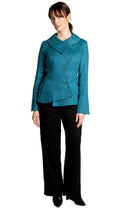 Woman wearing a teal blazer and black pants on a white background